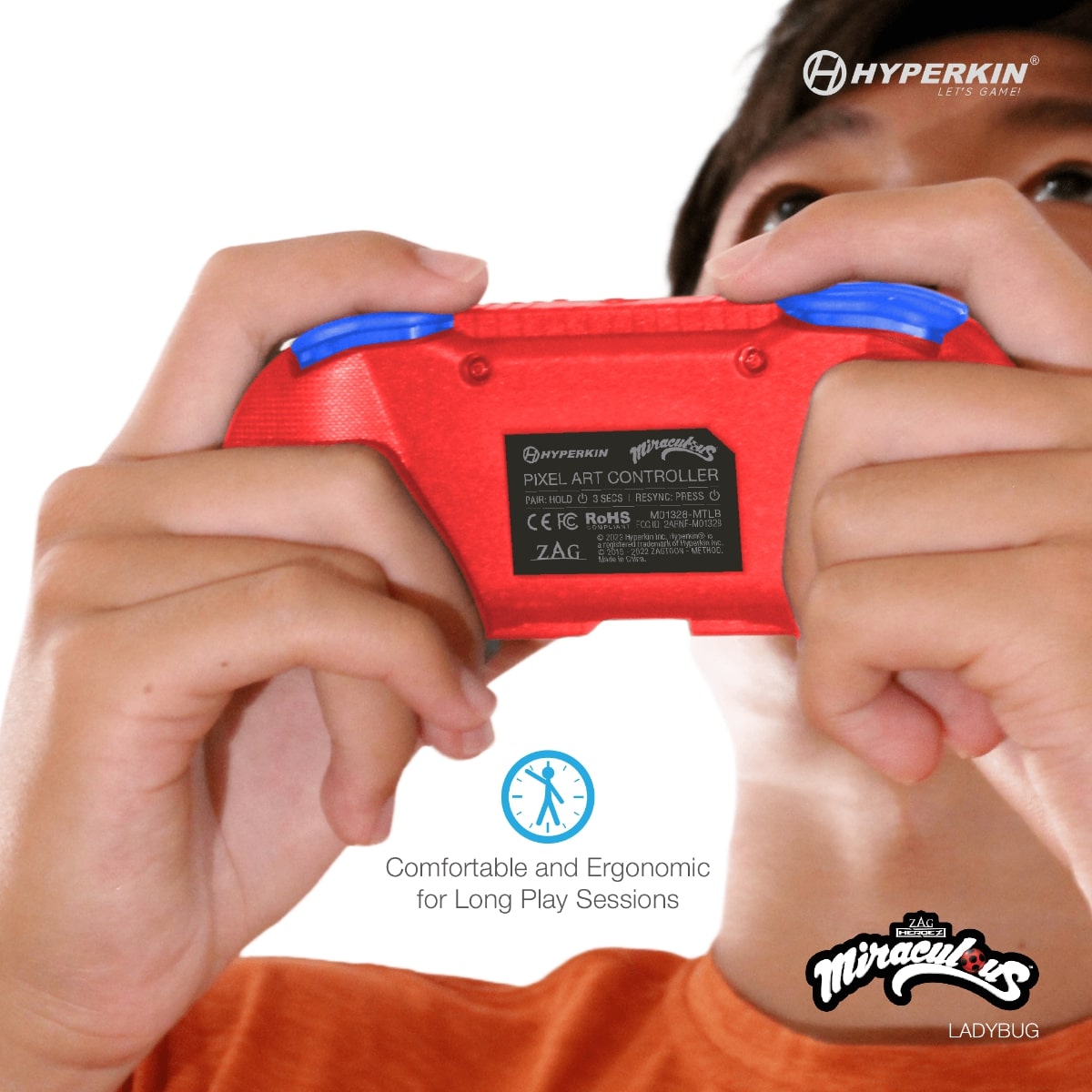 Person holding red and blue Hyperkin Pixel Art Controller with visible model label and ergonomic design; includes Hyperkin and Miraculous Ladybug branding, emphasizing comfort for long play sessions.