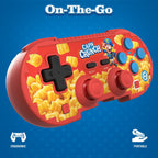 Hyperkin Cap’n Crunch Limited Edition Wireless Bluetooth Controller in red with Cap’n Crunch branding, dual joysticks, D-pad, and colorful buttons. Features ergonomic design and portability for Nintendo Switch, PC, Mac, and mobile gaming.