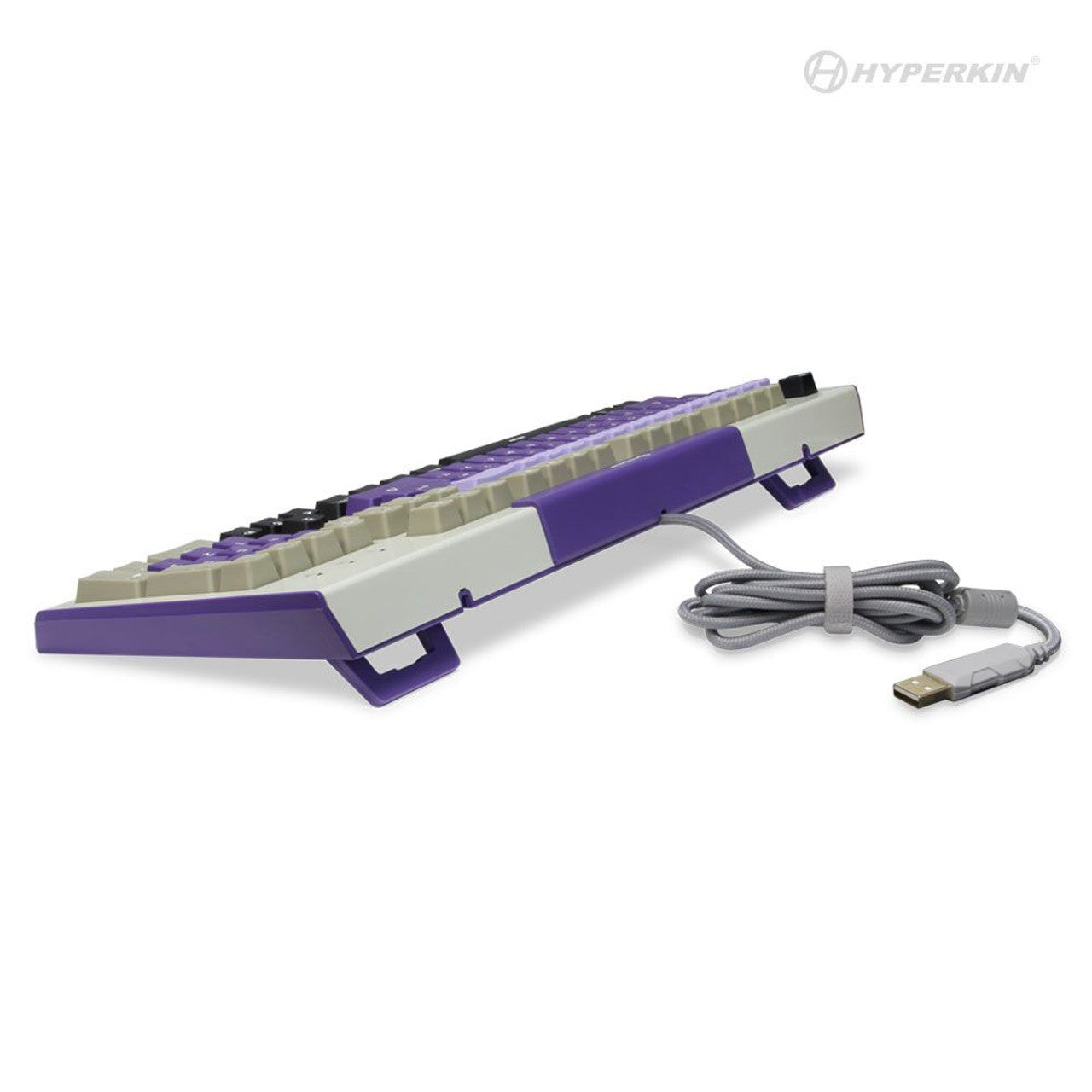 Side view of Hyperkin mechanical keyboard with purple and white keys, elevated on purple stands, coiled grey USB cable, and visible Hyperkin logo.