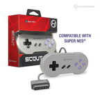 The image shows a Hyperkin Scout controller for the Super NES. The controller is gray with purple buttons and features a D-pad, Start and Select buttons, and four action buttons labeled X, Y, B, and A. The packaging is red and black with the Hyperkin logo and 'Scout' branding. Text on the image reads COMPATIBLE WITH SUPER NES