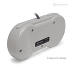 The image shows the back view of a Hyperkin Premium Controller for SNES. The controller is gray with a black label in the center that reads 'Hyperkin ITEM: M07286-P PREMIUM CONTROLLER FOR SNES MADE IN CHINA.' There are four screw holes visible on the back, and a cable protrudes from the top center. The text 'Ergonomic Design' is written in small font at the bottom right corner of the image.