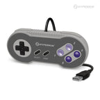 Hyperkin USB game controller with classic Super Nintendo design, featuring gray body, black D-pad, SELECT and START buttons, purple X/A/Y/B buttons, and attached USB cable for connectivity.