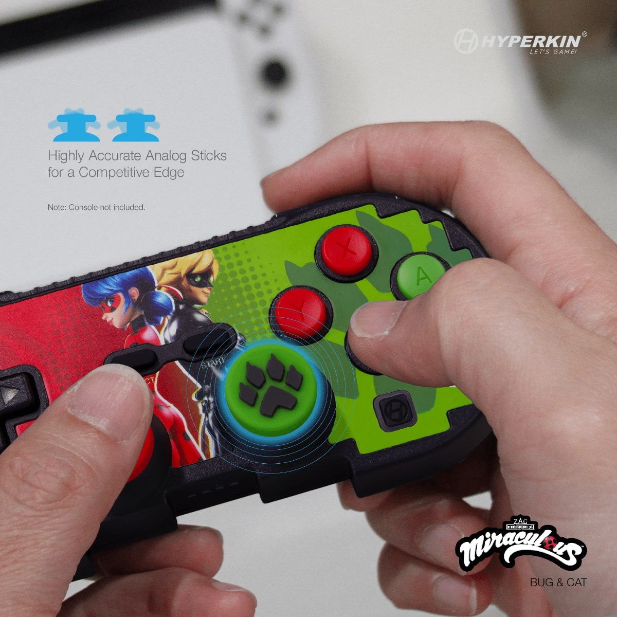 Hands holding Hyperkin gaming controller with Miraculous Ladybug and Cat Noir design, featuring precision analog sticks for competitive gameplay; console not included.